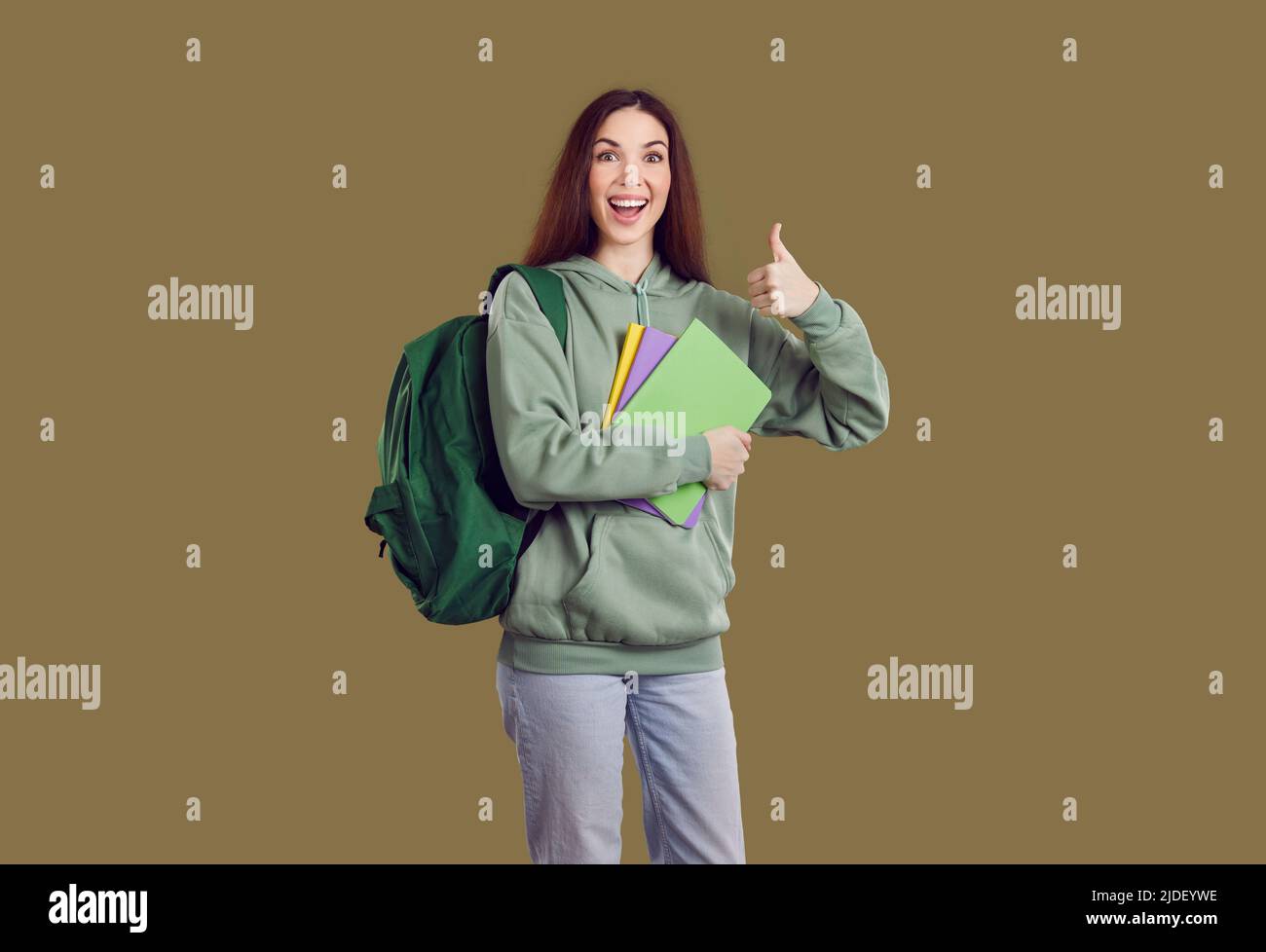 Happy university student girl with books and backpack smiling and ...
