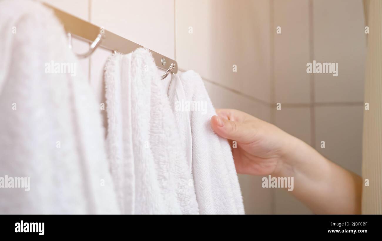 Woman pulls curtain and takes towel during taking shower Stock Photo Alamy