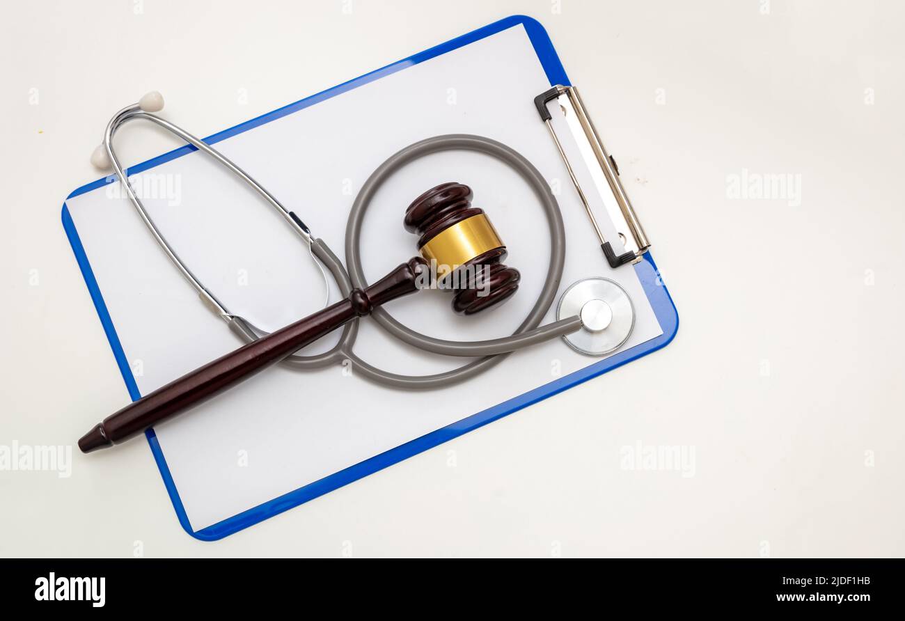 Healthcare and Law concept, Medical malpractice, personal injury lawyer. Judge gavel and doctor clipboard isolated on white, top view Stock Photo