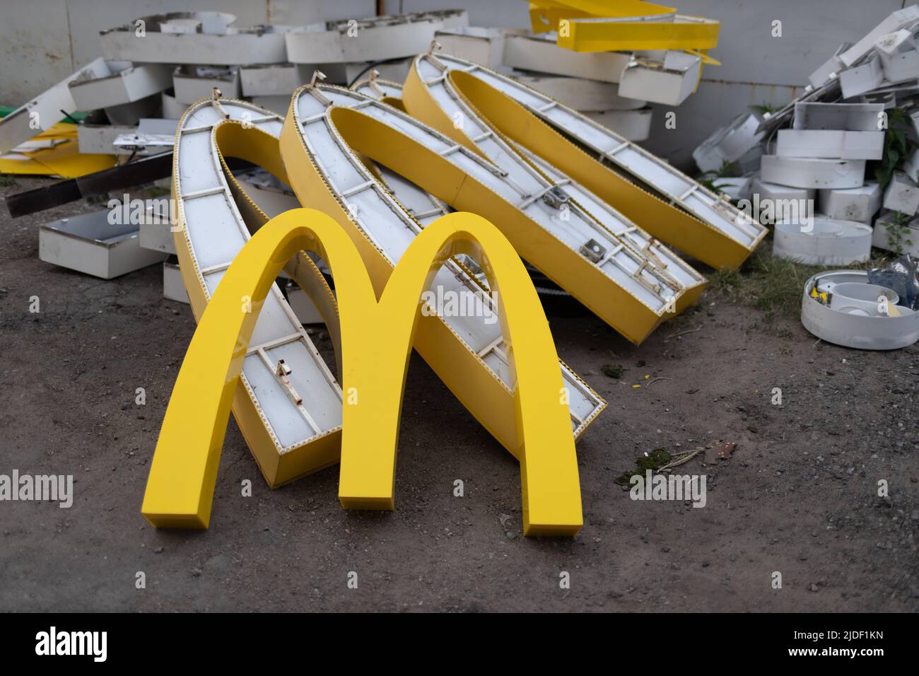 Moscow, Russia - 06.21.2022: McDonalds logo letter character M on dirty rubbish heap dump trash litter garbage. Fast food and sanctions concept. Envir Stock Photo
