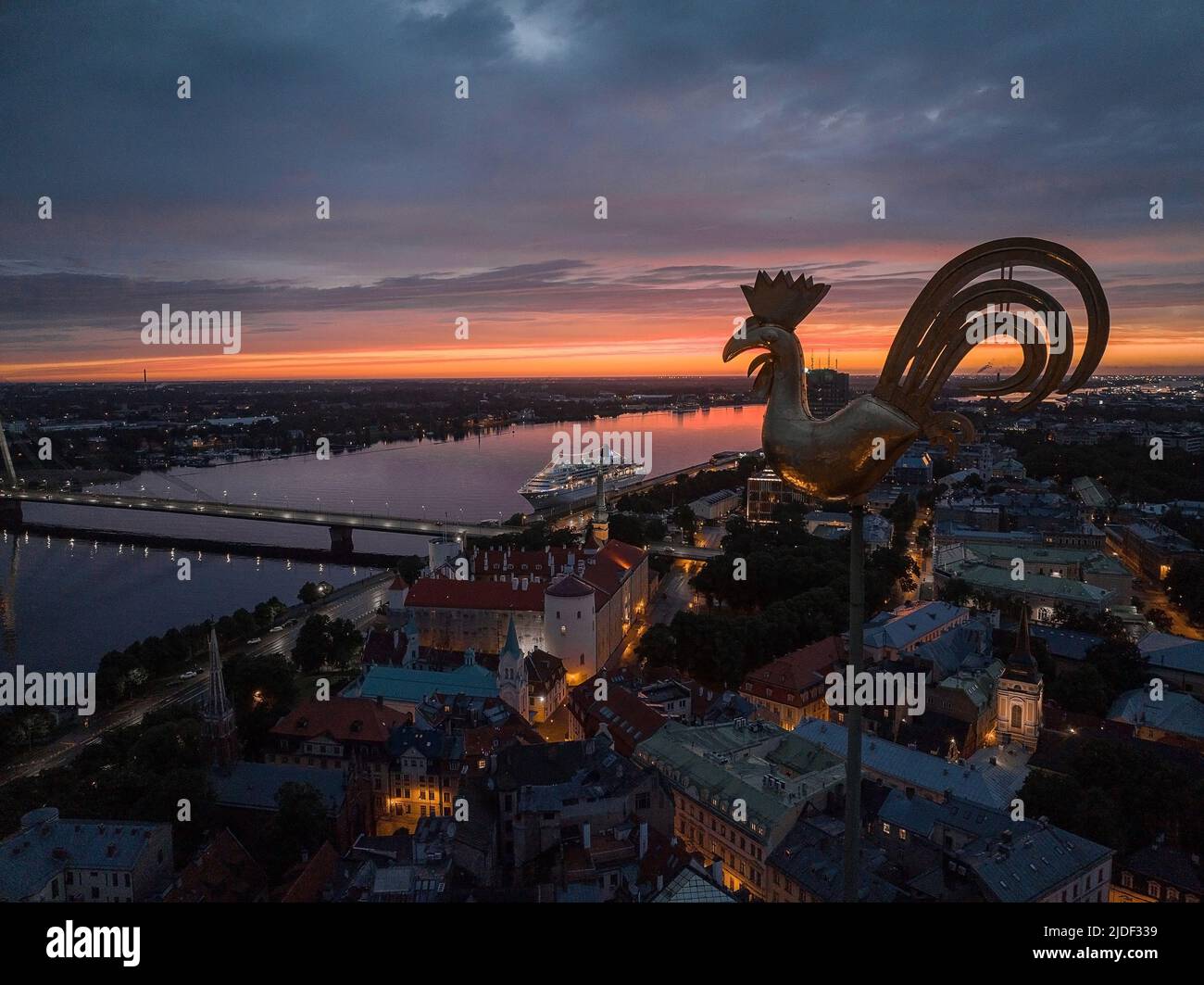 Symbol of old Riga town - golden cockerel, rooster topping bell tower