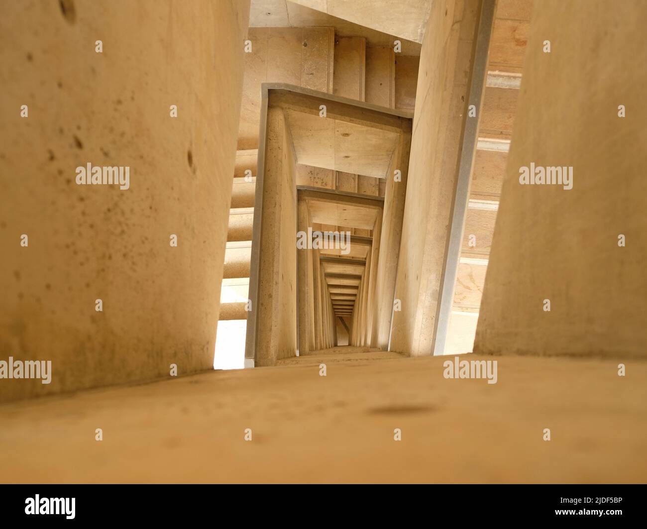 Top Down View of Stairs. Emergency Exit Concept. The winding stairs are empty. Abstract beige background. Stock Photo