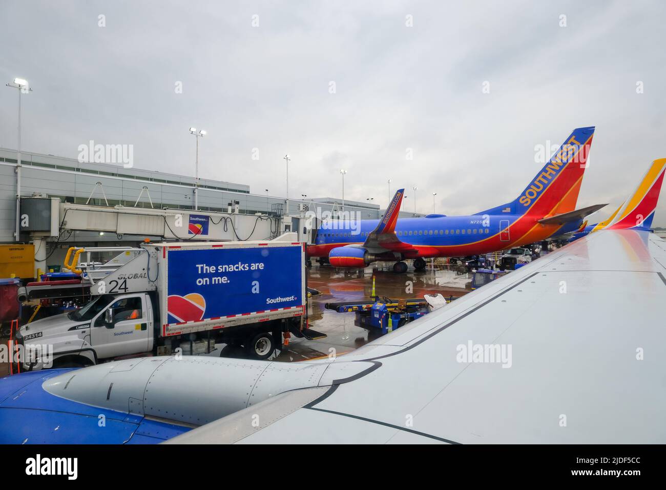 Stock images of South West Airlines at gate with plane support vehicles. Luggage and ground crew. Stock Photo