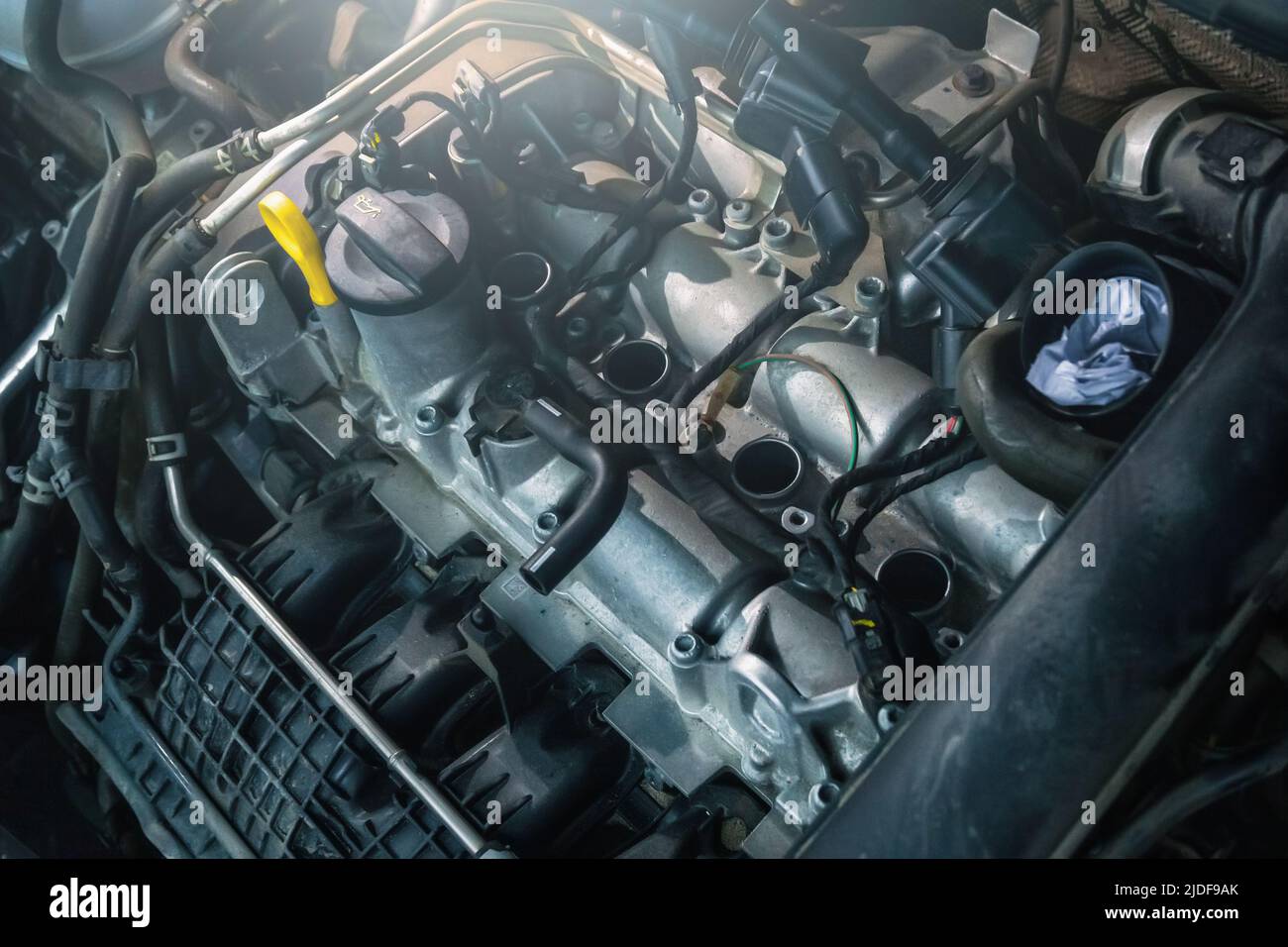 Modern turbo engine in process of changing spark plugs. Interval replacement of consumables and car maintenance. Stock Photo