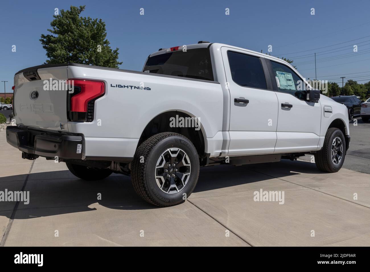 Zionsville - Circa June 2022: Ford F-150 Lightning display. Ford offers the F150 Lightning all-electric truck in Pro, XLT, Lariat, and Platinum models Stock Photo