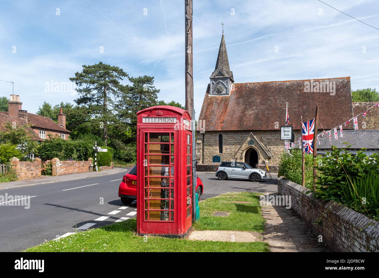 Plaistow village in West Sussex, England, UK. View of the village centre with Holy Trinity Church and red telephone box Stock Photo