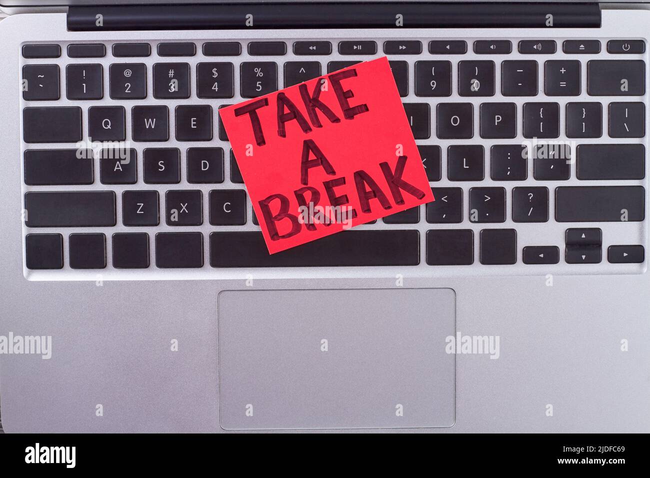 Paper with message take a break on keyboard. Urge for hard worker. Stock Photo