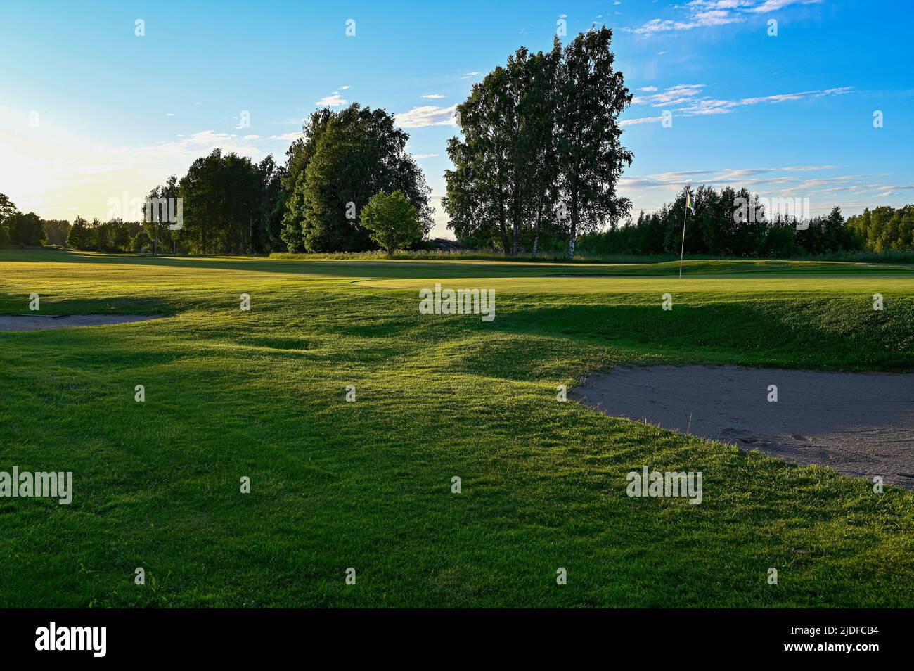 evening light over golf course in Kumla Sweden Stock Photo
