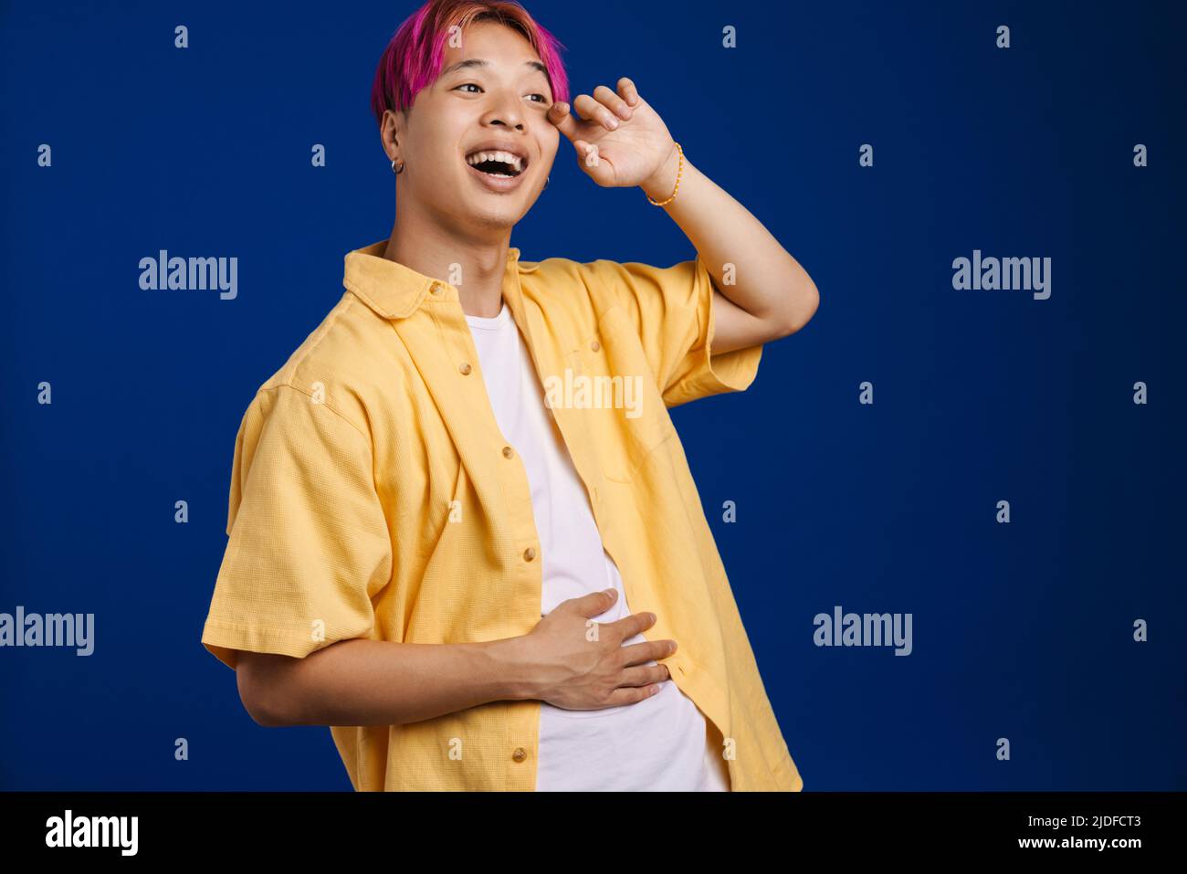 Asian boy with pink hair laughing and looking aside isolated over blue background Stock Photo - Alamy Asian boy with pink hair laughing and looking aside isolated over blue background Stock Photo - Alamy