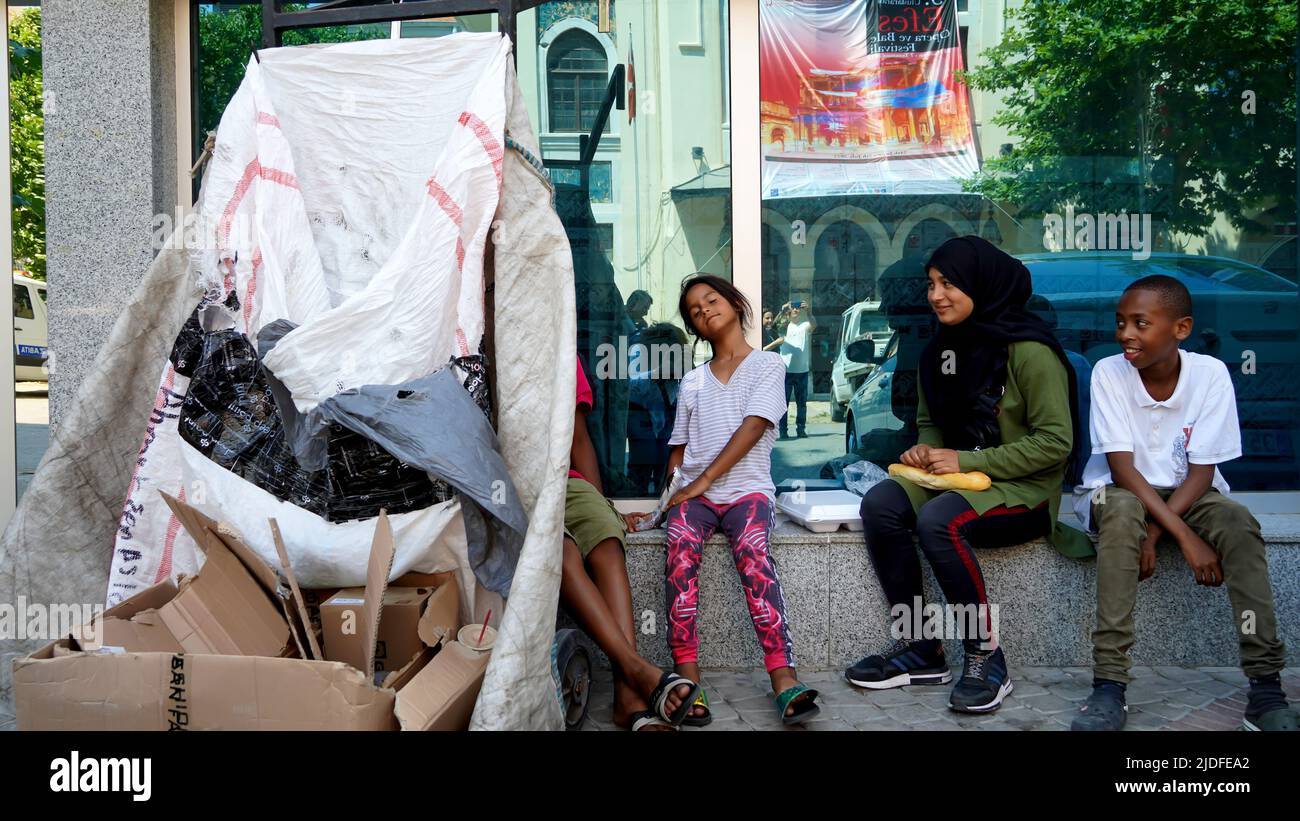 Turkey. 20/06/2022, Syrian and African child refugees struggle to make a living by collecting and selling paper and cardboard for recycling, and sometimes selling handkerchiefs for asking alms. They are the children of families who migrated to Turkey as refugees due to war, economical and political reasons. Child refugees who go to Turkish schools and speak Turkish language well, work out of school days at their early age. They earn between 25 TL and 100 TL per day. The eldest of the group, the teenager Syrian girl, says that they fled the war 8 years ago and took refuge in Turkey. Child refug Stock Photo