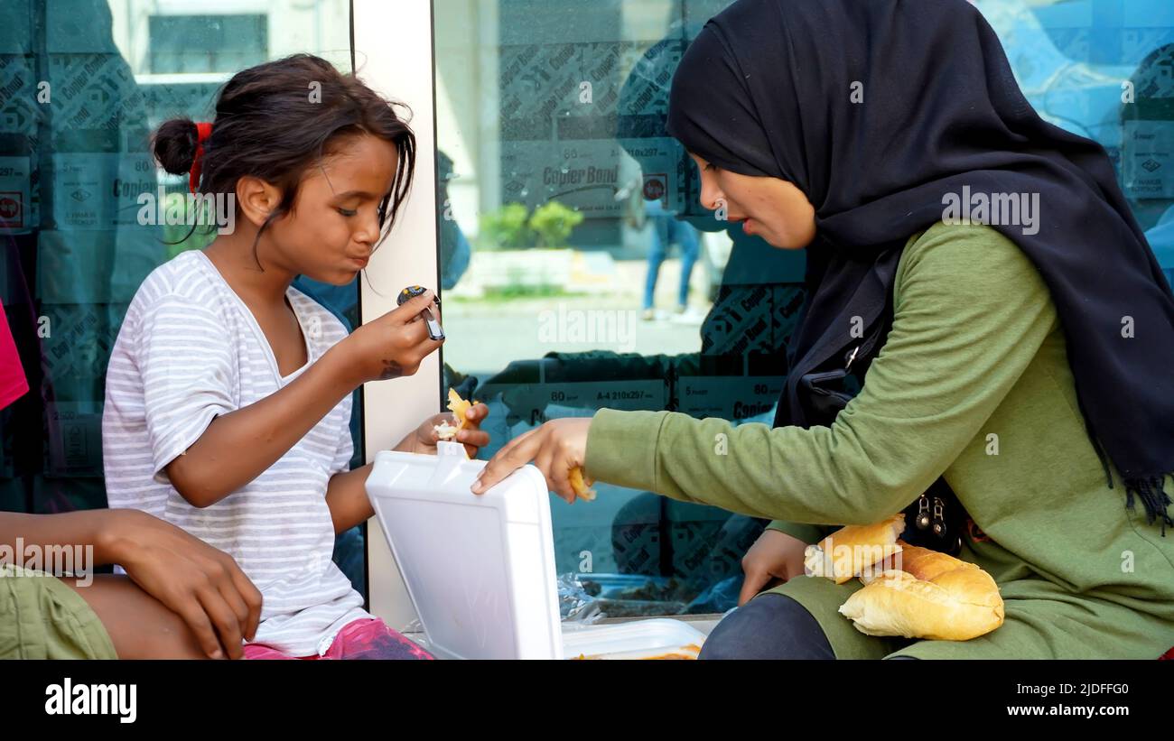 Turkey. 20/06/2022, Syrian and African child refugees struggle to make a living by collecting and selling paper and cardboard for recycling, and sometimes selling handkerchiefs for asking alms. They are the children of families who migrated to Turkey as refugees due to war, economical and political reasons. Child refugees who go to Turkish schools and speak Turkish language well, work out of school days at their early age. They earn between 25 TL and 100 TL per day. The eldest of the group, the teenager Syrian girl, says that they fled the war 8 years ago and took refuge in Turkey. Child refug Stock Photo