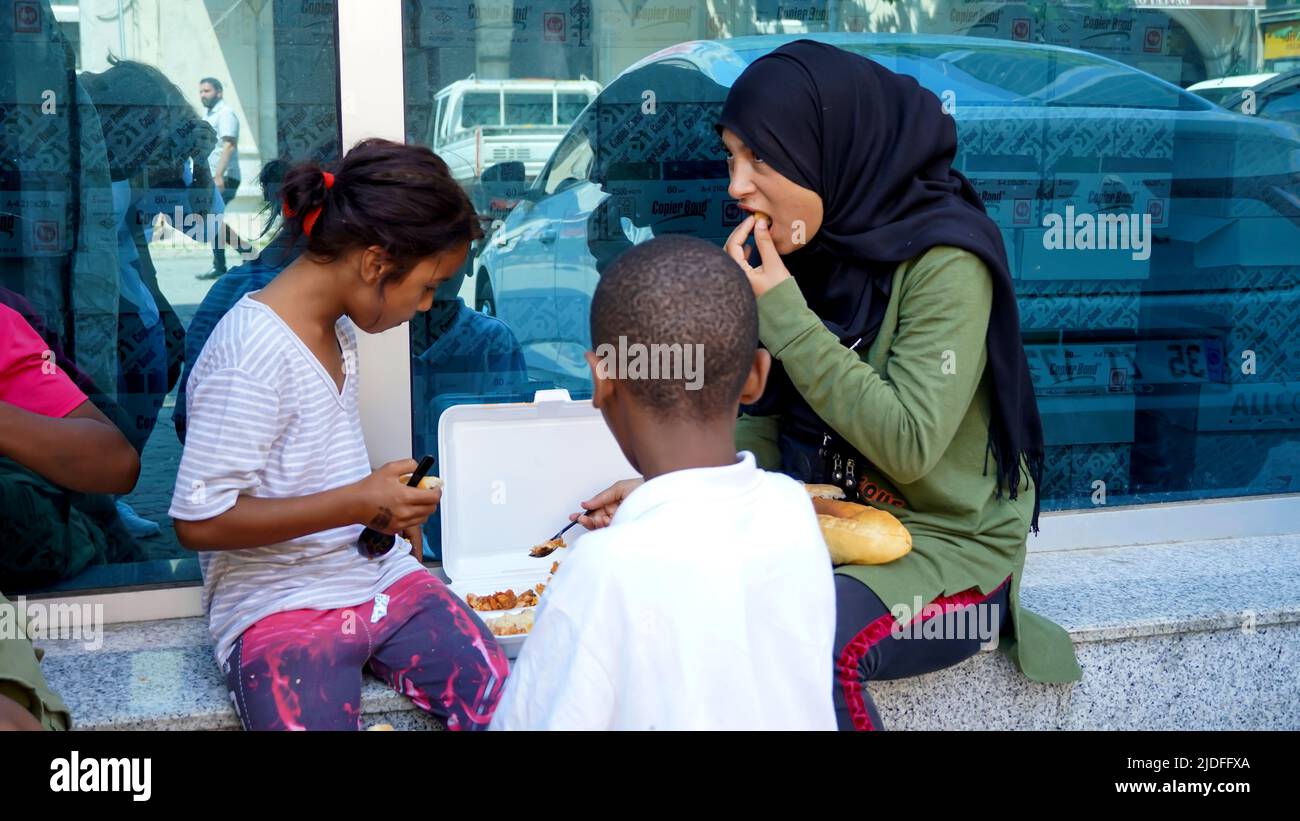 Turkey. 20/06/2022, Syrian and African child refugees struggle to make a living by collecting and selling paper and cardboard for recycling, and sometimes selling handkerchiefs for asking alms. They are the children of families who migrated to Turkey as refugees due to war, economical and political reasons. Child refugees who go to Turkish schools and speak Turkish language well, work out of school days at their early age. They earn between 25 TL and 100 TL per day. The eldest of the group, the teenager Syrian girl, says that they fled the war 8 years ago and took refuge in Turkey. Child refug Stock Photo