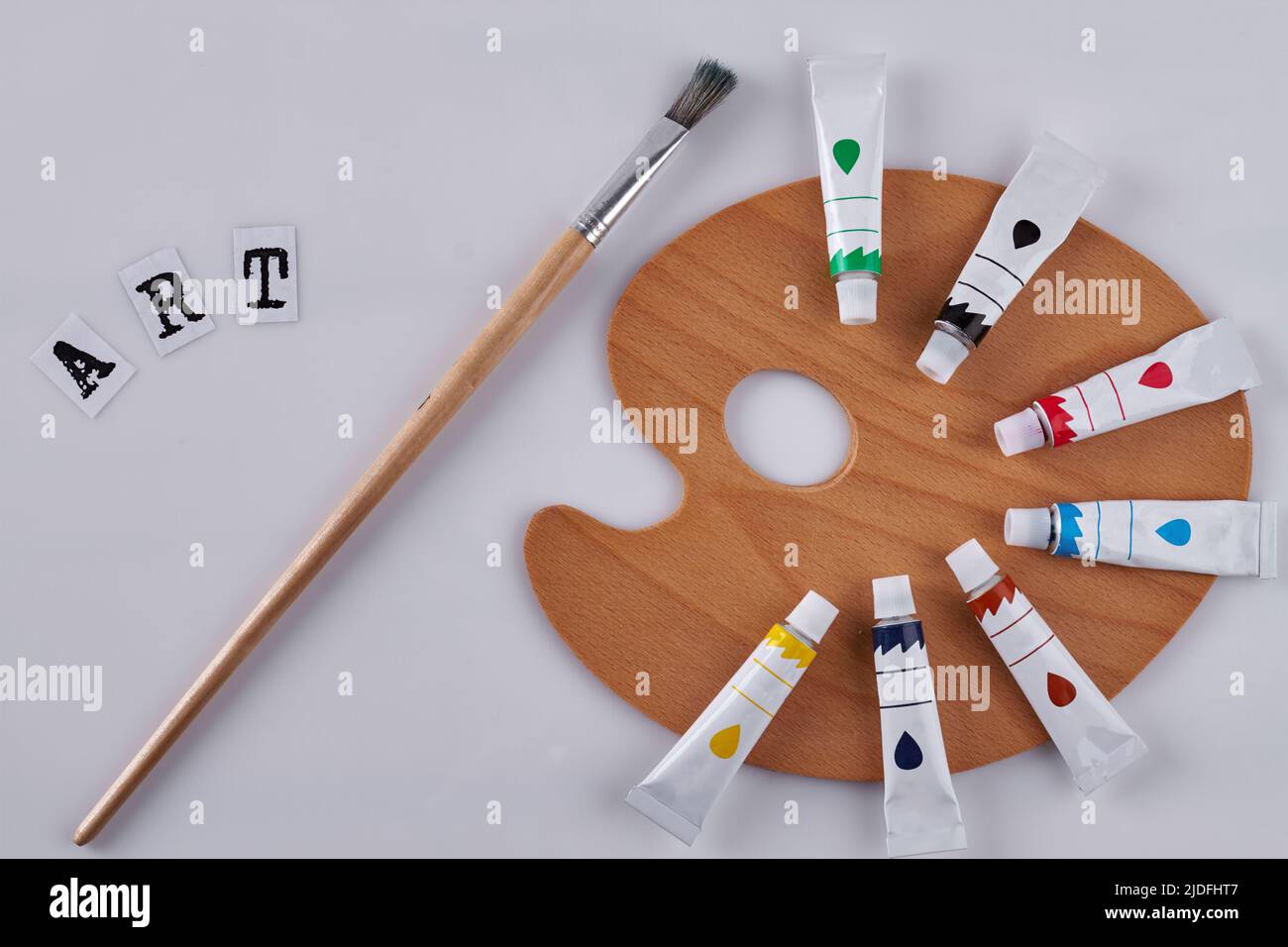 Paint brush and clean wooden palette on white background. Paintbrush