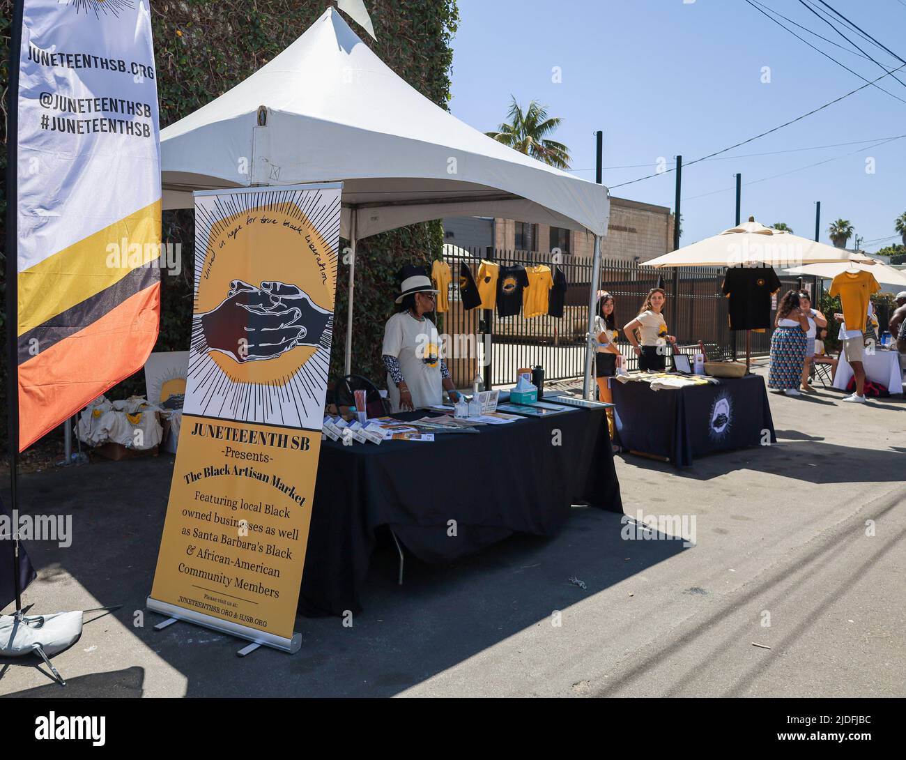 Santa Barbara, California, USA. 19th June, 2022. Sign with Juneteenth SB logo of black hands and words, 'United in Hope for True Black Liberation'' at gateway to the Juneteenth Black Artisan Market during the Santa Barbara celebration, at the 200 E. Grey Ave. block, on June 19, 2022. Pacifica Graduate Institute Alumni Association Director Dianne Travis Teague wo-man's the welcome booth. (Credit Image: © Amy Katz/ZUMA Press Wire) Stock Photo