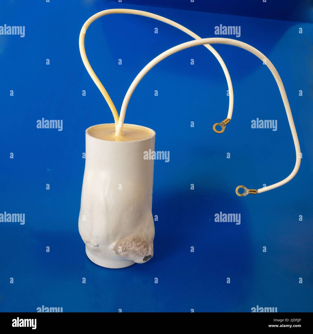 Swollen Electrolytic Capacitor (condenser or condensator) on blue