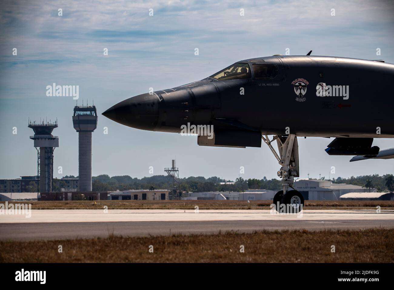 A U.S. Air Force B-1B Lancer attached to the 34th Bomb Squadron, Ellsworth, South Dakota, taxies past the control towers of the Darwin Airport after landing at the Royal Austrailian Air Force Base, Darwin, NT, Austraila, June 20, 2022. Bomber missions contribute to joint force lethality and deter aggression in the Indo-Pacific by demonstrating United States Air Force ability to operate anywhere in the world at any time in support of the National Defense Strategy. (U.S. Air Force Photo by Technical Sgt. Chris Hibben) Stock Photo