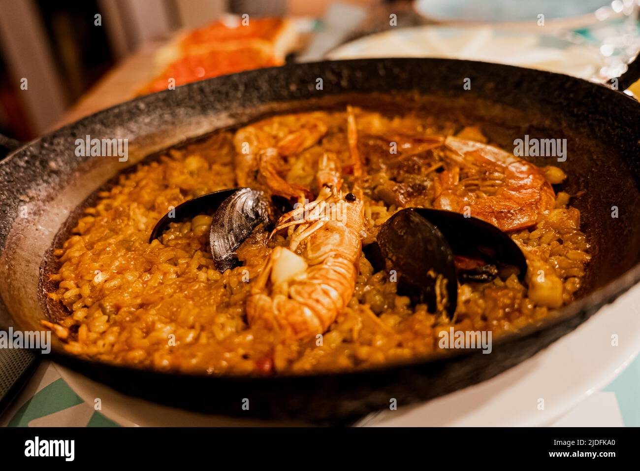 Paella, the traditional dish in Spain. Rustic cast iron skilled filled