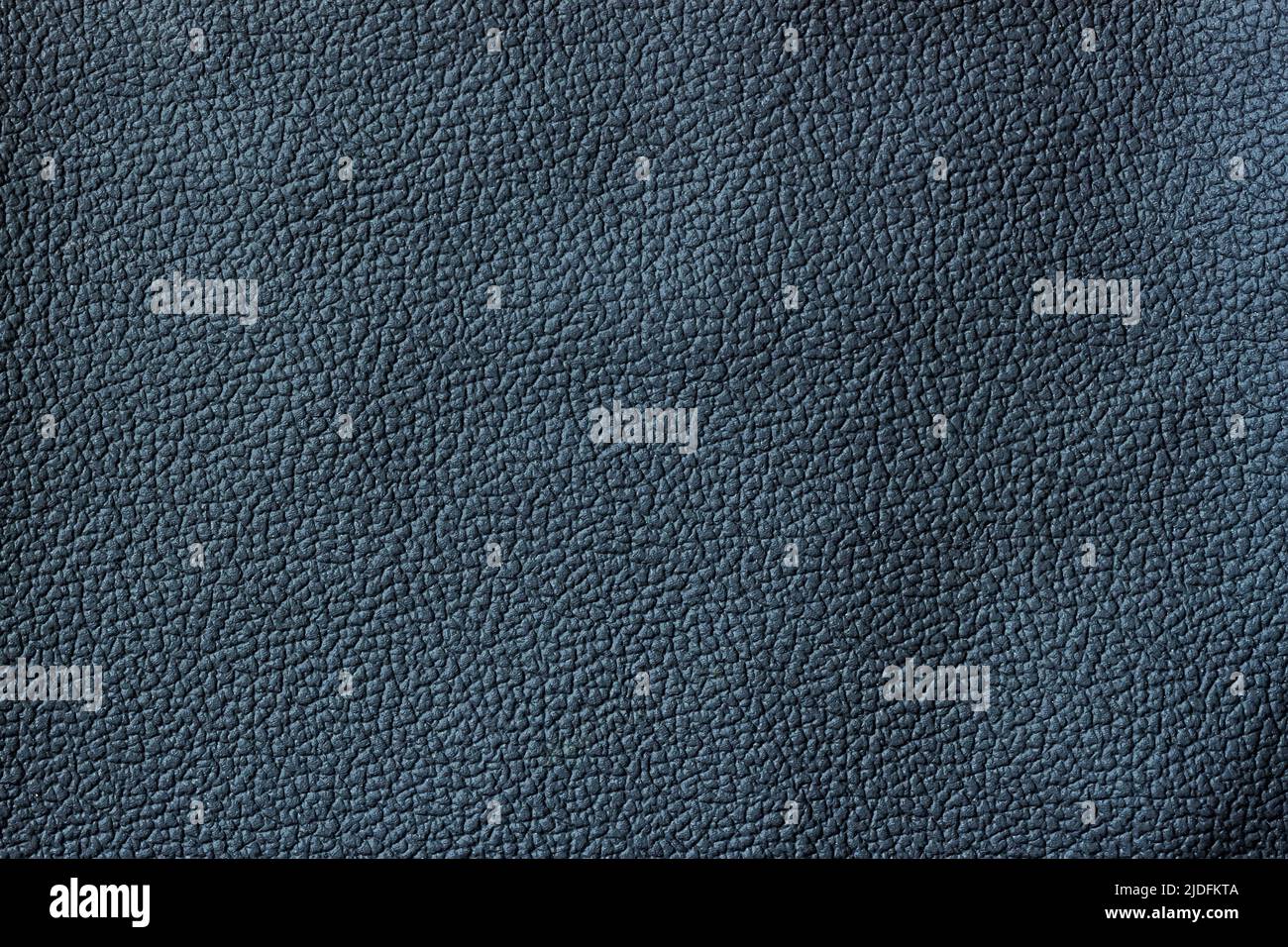 Texture of dark genuine leather close-up, granular texture of surface Stock Photo