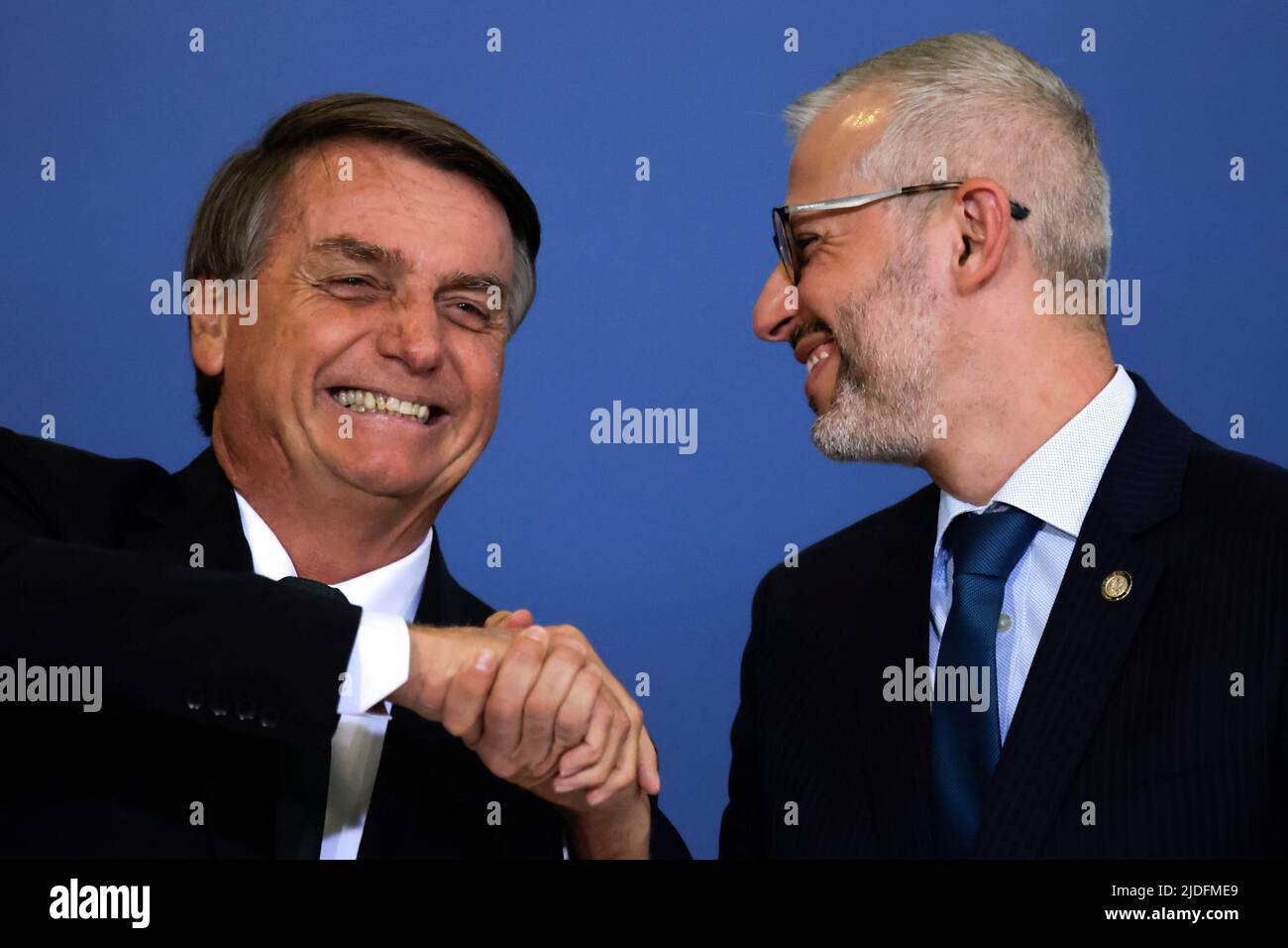 Brazil's President Jair Bolsonaro shakes hands with Brazil's Education Minister Victor Godoy during a ceremony about the National Policy for Education at the Planalto Palace in Brasilia, Brazil June 20, 2022. REUTERS/Ueslei Marcelino Stock Photo