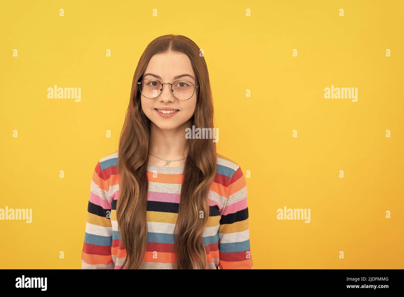 smiling schoolgirl nerd child in eyeglasses for vision, school Stock Photo