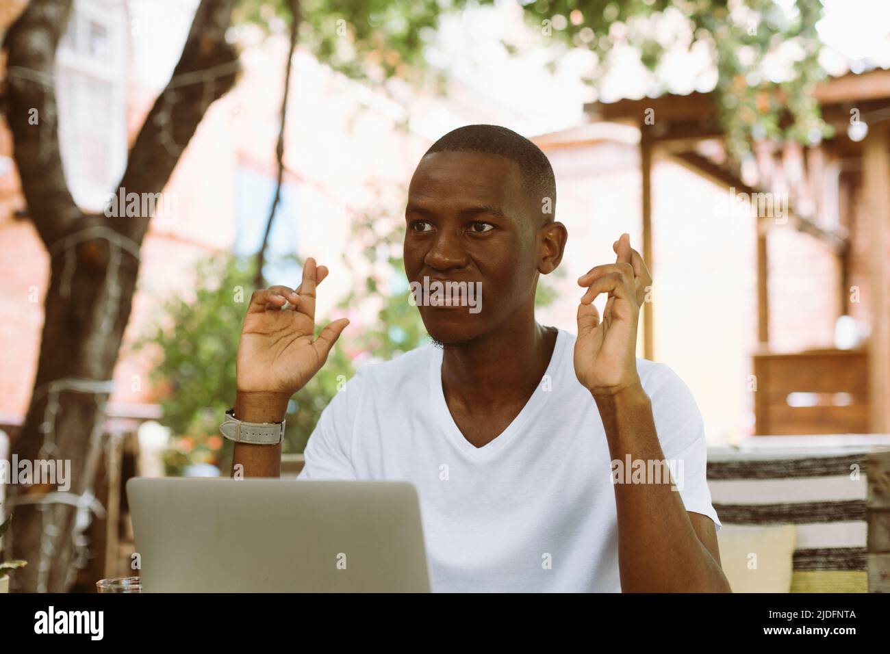 Smiling african american businessman work on laptop in the cafe ...