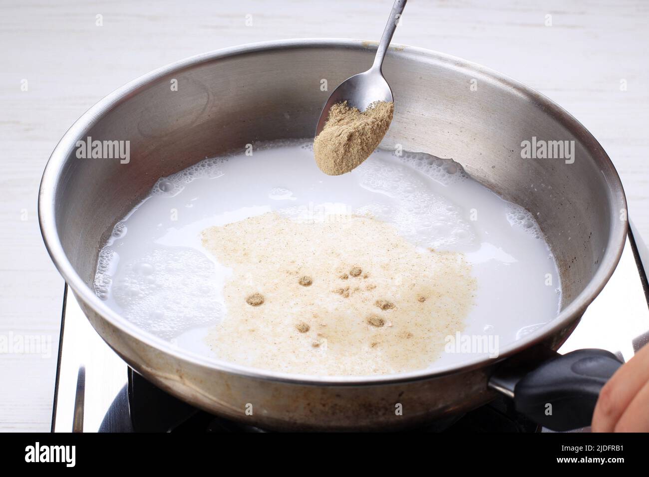 Pour Chicken Powder Stock MSG to the Pan, Cooking Process Stock Photo