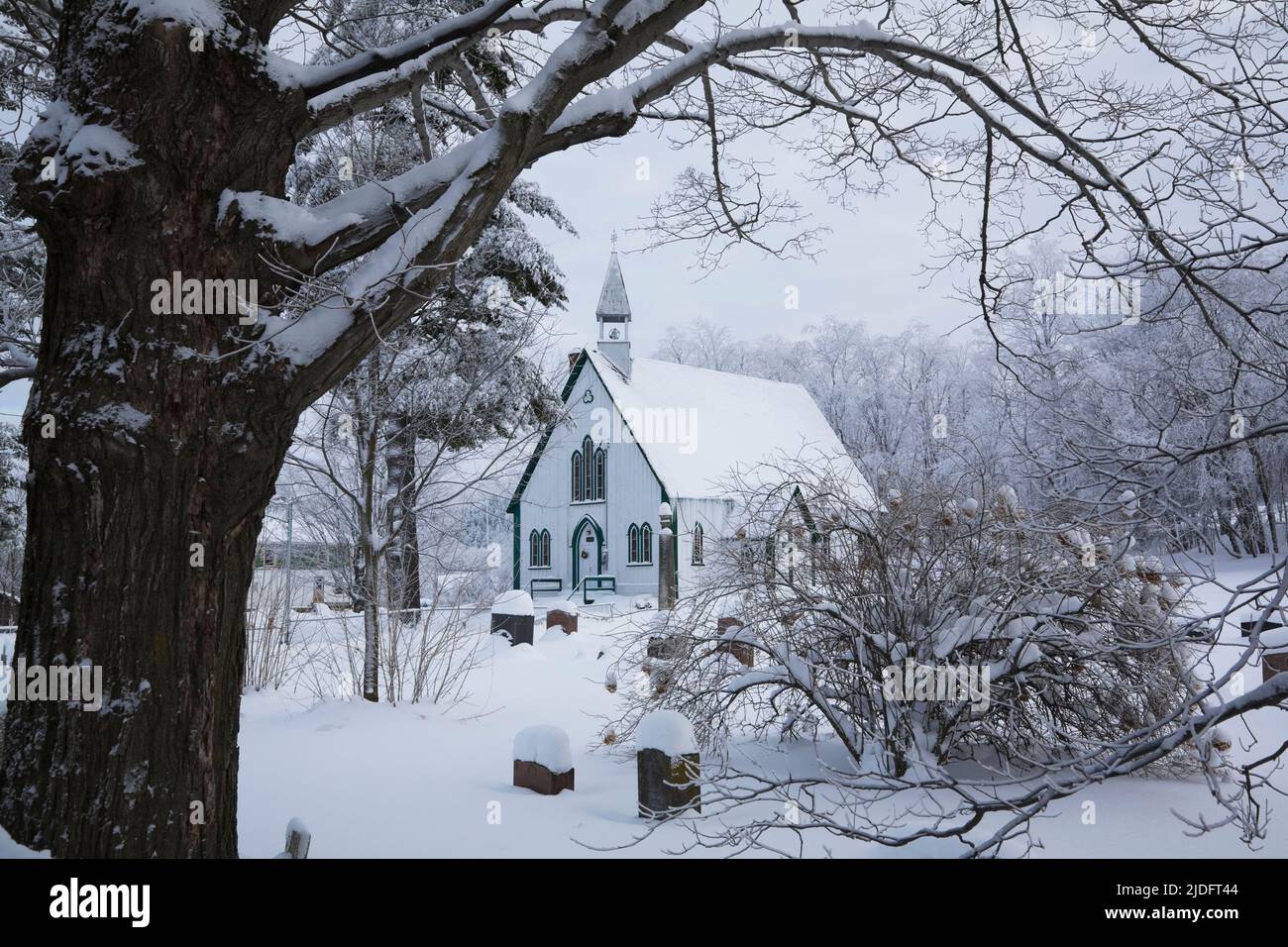 Holy Trinity Anglican church and cemetery in winter, Iron Hill, Eastern Townships, Quebec, Canada. Stock Photo
