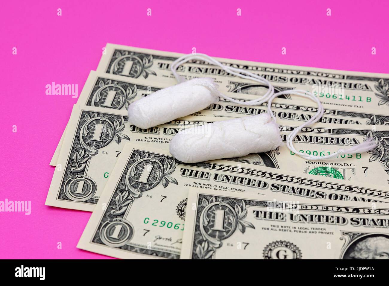 Tampons and cash money. Tampon shortage, tax, pink tax and feminine hygiene products price increase concept Stock Photo