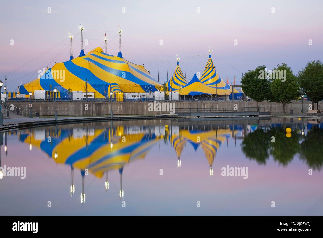 Cirque du Soleil Big Top tent installations reflected in the Bonsecours Bassin at dawn, Old Port of Montreal, Quebec, Canada. Stock Photo