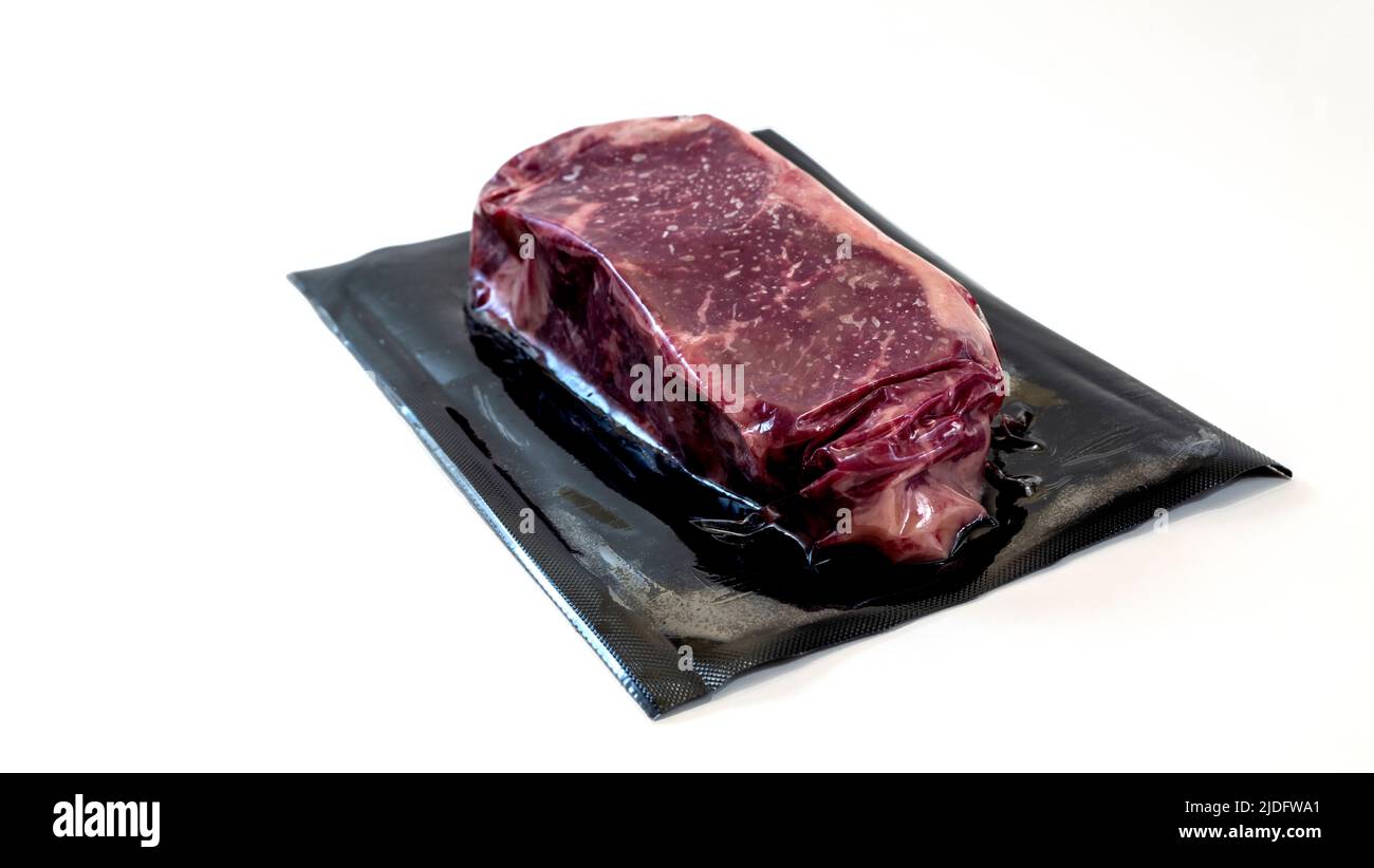 raw piece of beef for steak in vacuum packaging isolated on white