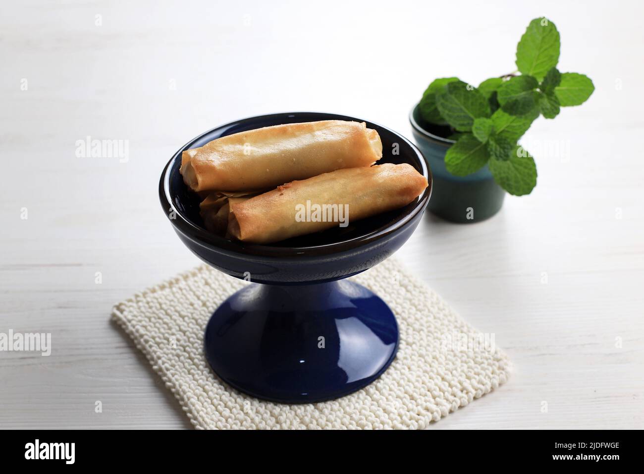 Sweet Spring Roll, Deep Fried Lumpia with Fruit and Banana Inside, on White Table Stock Photo
