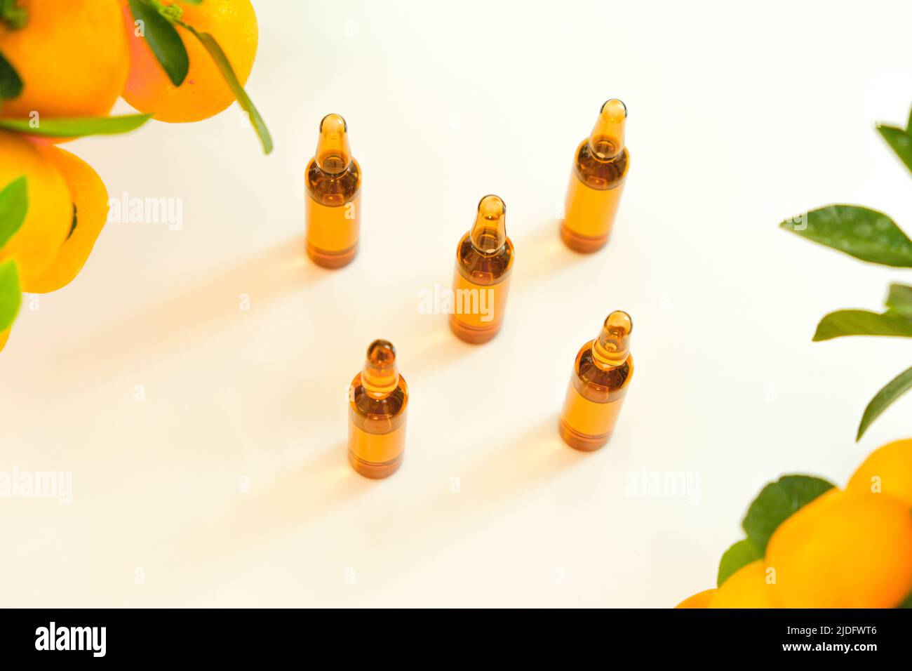 Vitamin C .ampoules with a solution of vitamin C and tangerine bushes