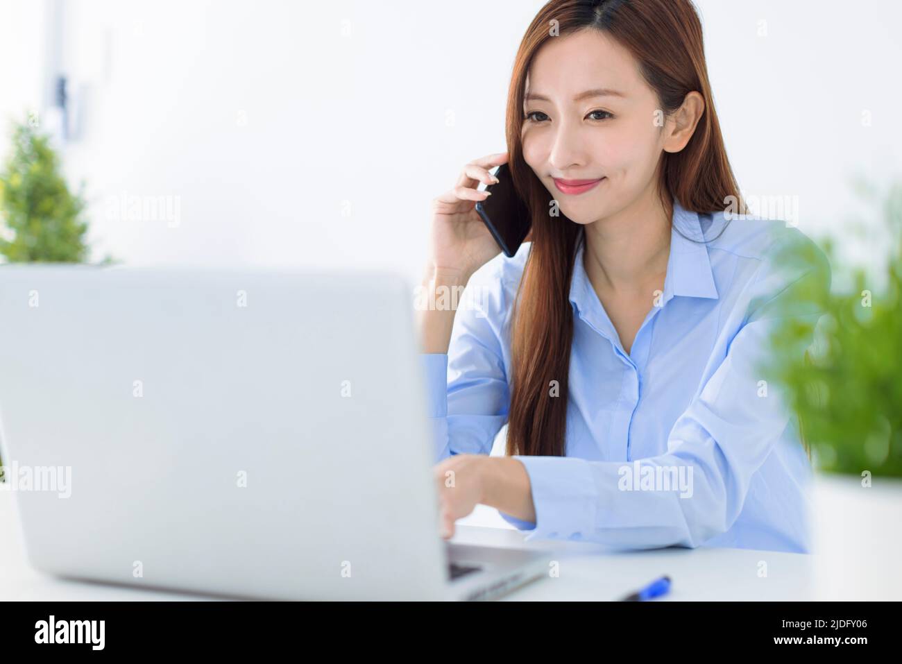 Beautiful young business woman working in the office Stock Photo