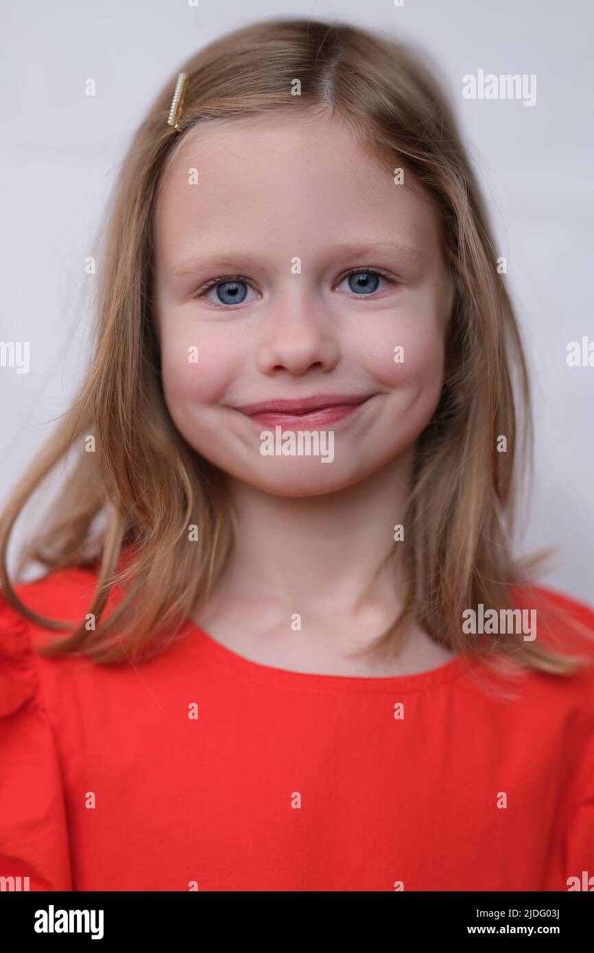 Little smiling girl posing and looking at camera with gladness Stock Photo