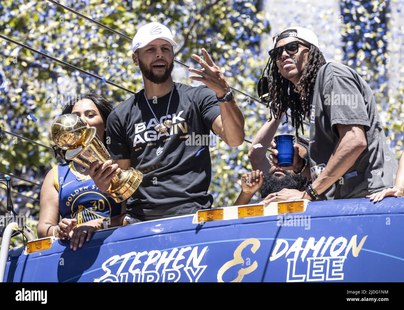 San Francisco, United States. 20th June, 2022. Golden State Warriors Stephen  Curry (L) holds his NBA Finals MVP trophy next to Damion Lee during a  parade up Market Street to honor the