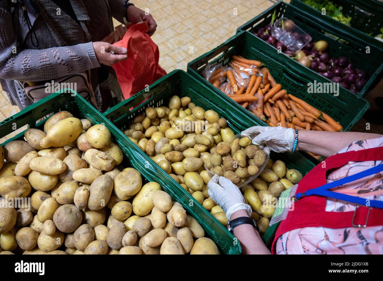 Berlin, Germany. 14th June, 2022. A volunteer distributes potatoes at