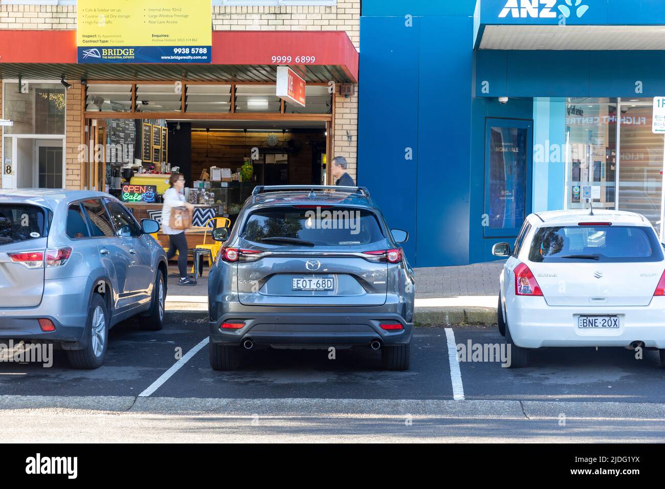 2021 Mazda CX9 SUV parked alongside 2009 white Suzuki Swift car in Mona Vale,Sydney,NSW,Australia Stock Photo