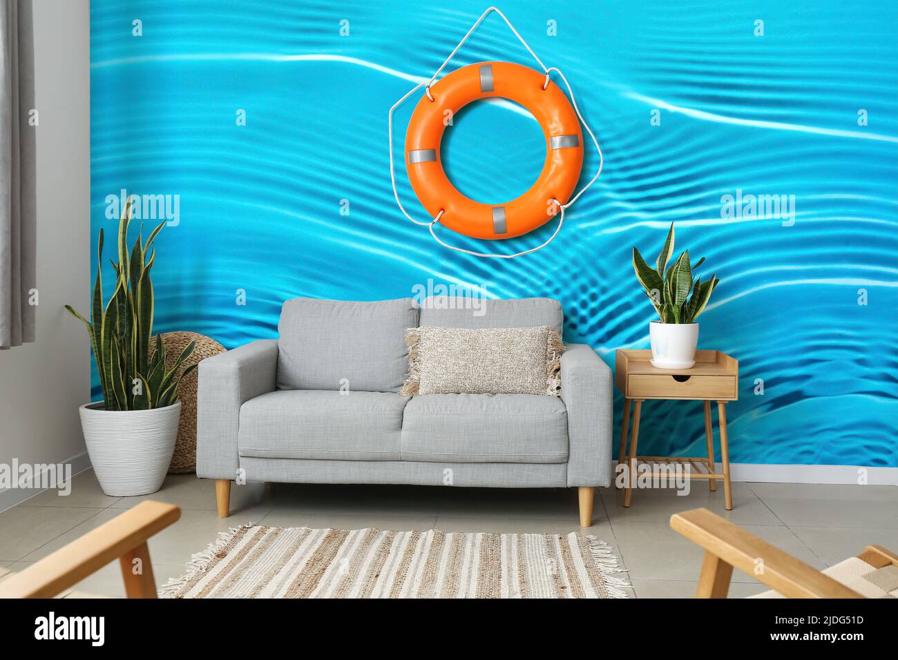 Interior of modern living room with sofa near wall with lifebuoy and