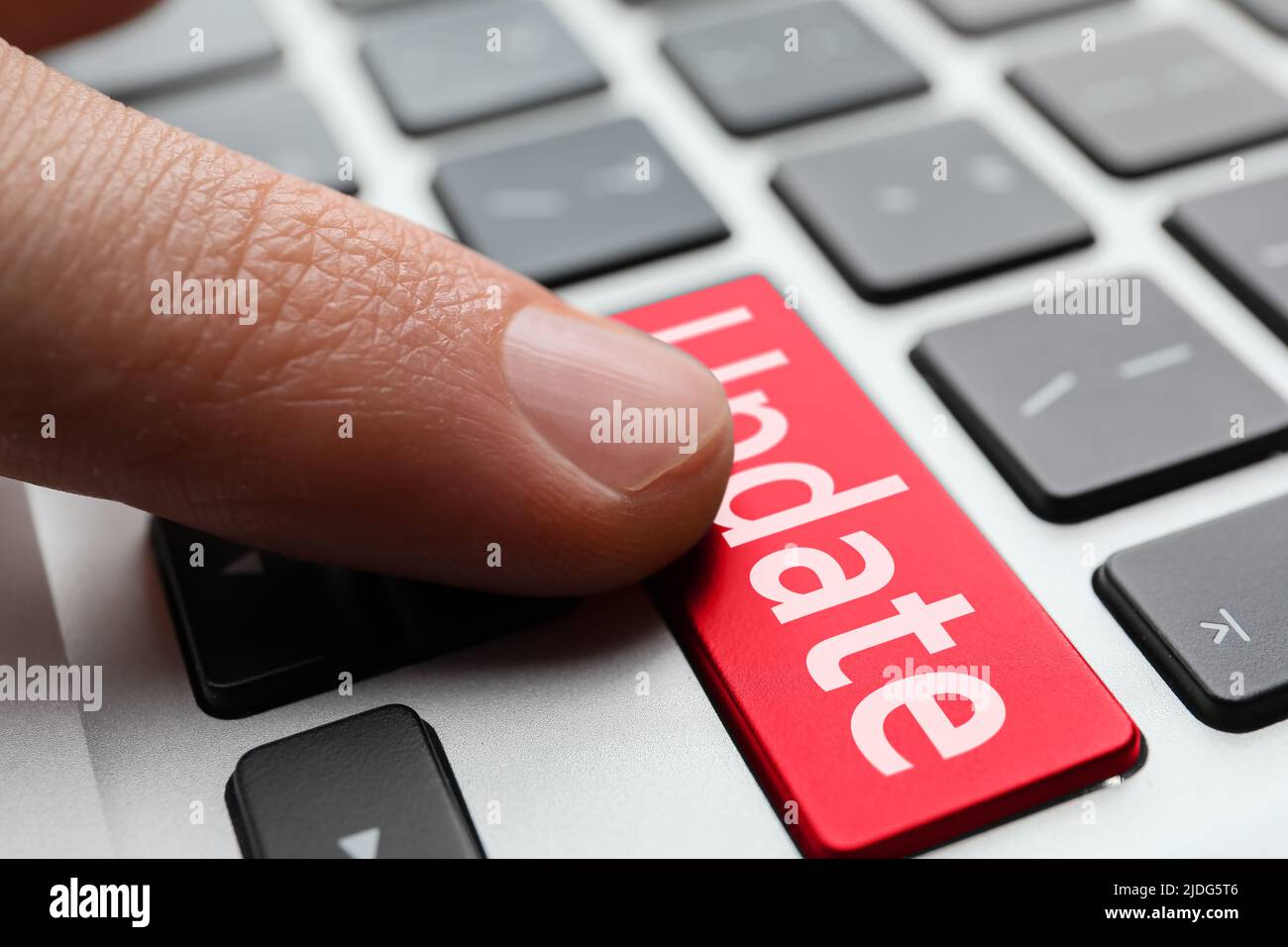 Man pressing button with word UPDATE on modern computer keyboard, closeup Stock Photo