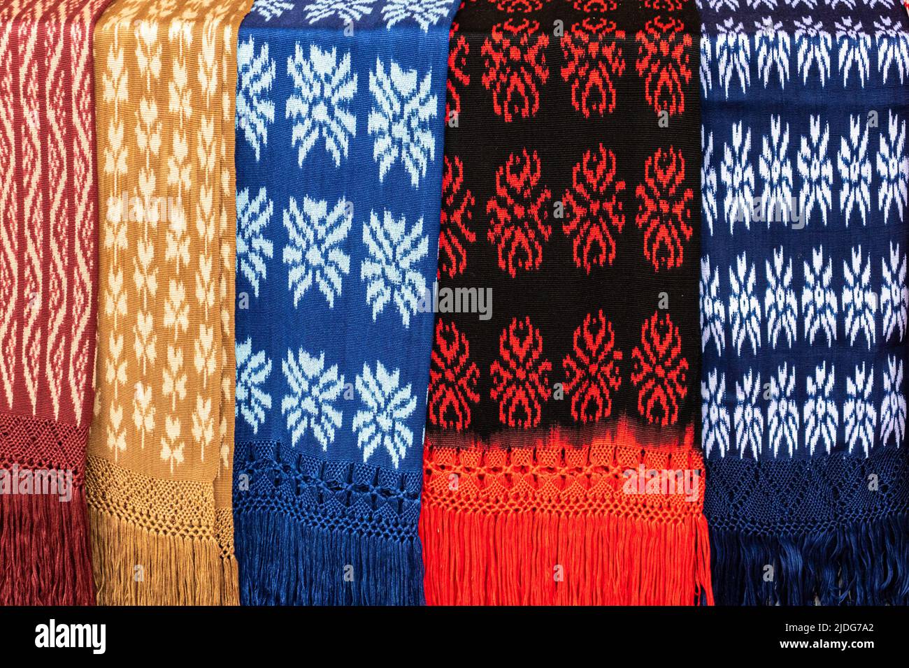 Scarves or Macanas at the market, traditional handcraft and design for Gualaceo canton, Azuay province, made by using technique called Ikat. Colorful Stock Photo