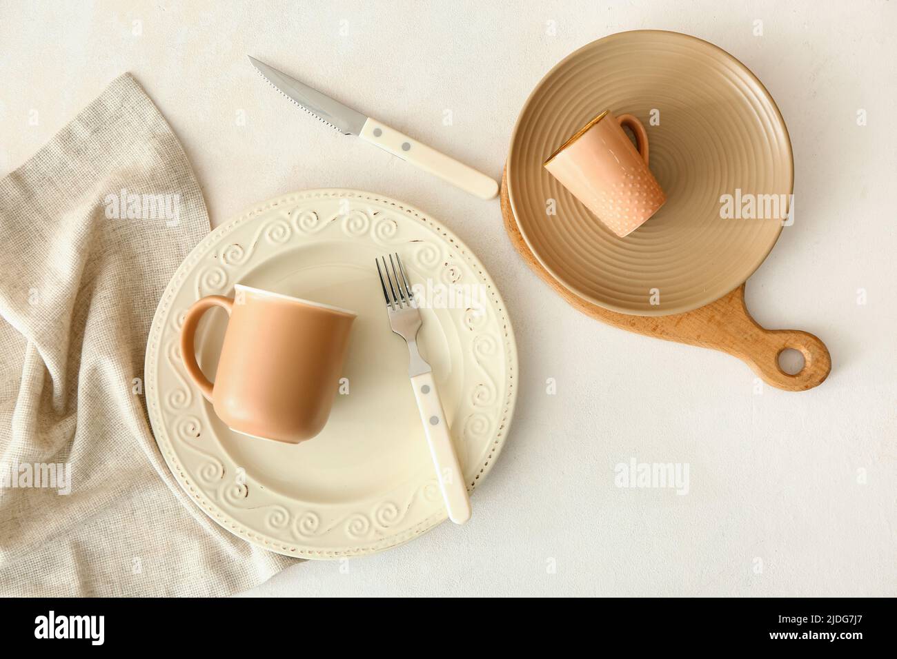 Simple table setting with plates and cups on white background Stock ...