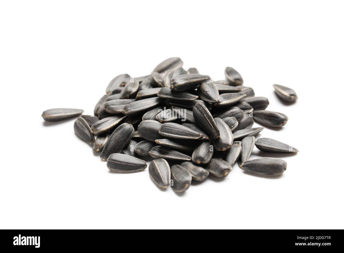 Pile of unpeeled sunflower seeds on white background Stock Photo - Alamy