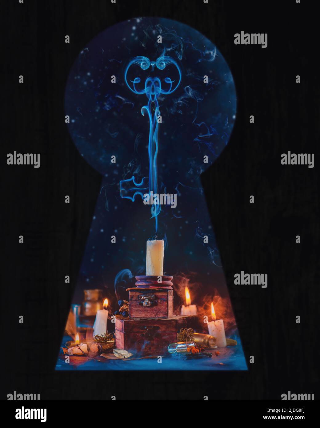 Keyhole looking on candles with smoke in the shape of a key, magical scene Stock Photo