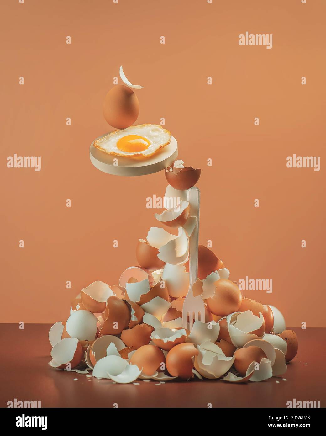 Pile of egg shells with a fried egg balancing on a fork, equilibrium, creative food photo Stock Photo