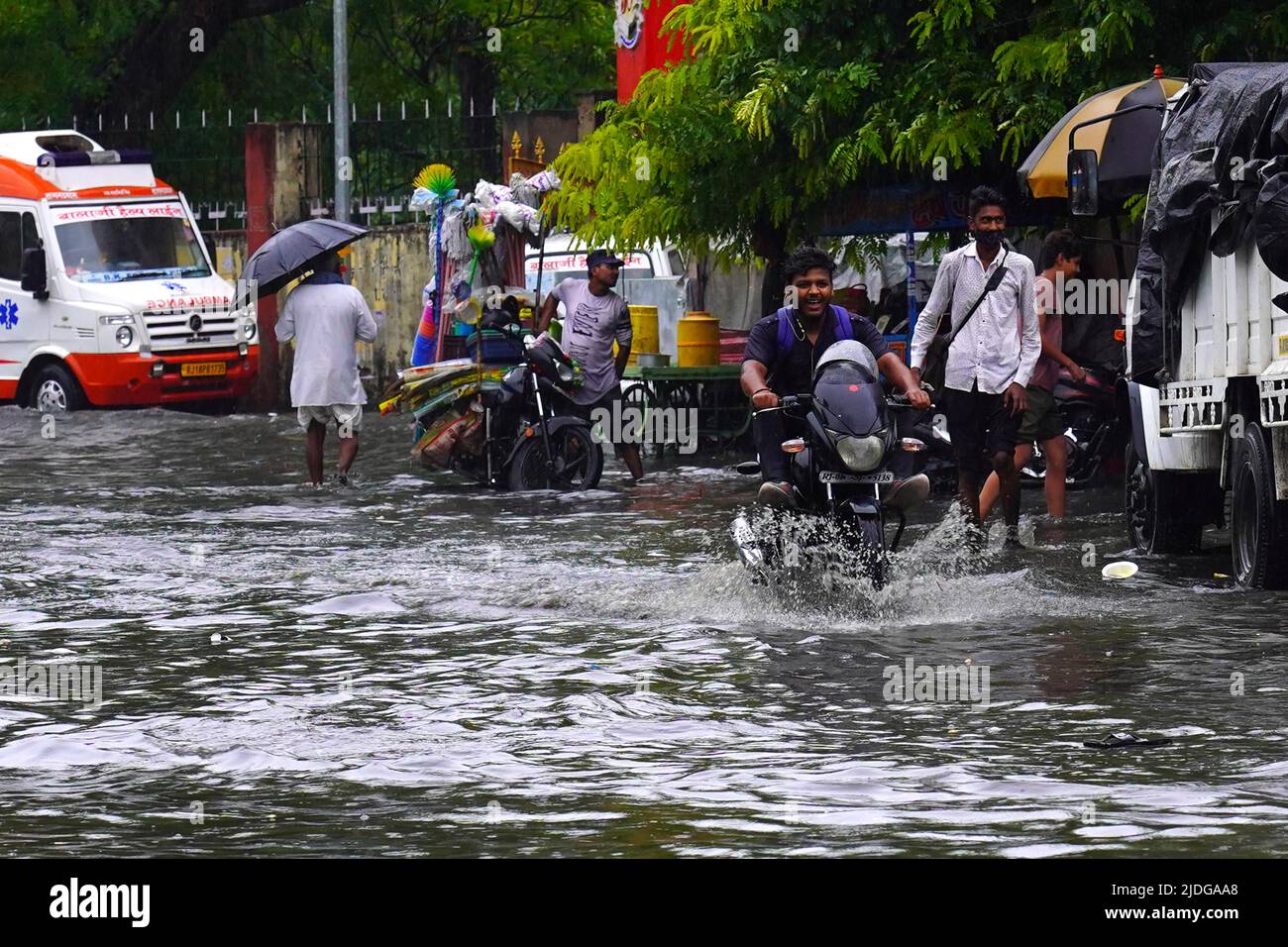 Rajasthan India On June 20 2022 Indian People Make Their Way Through A Waterlogged Road After