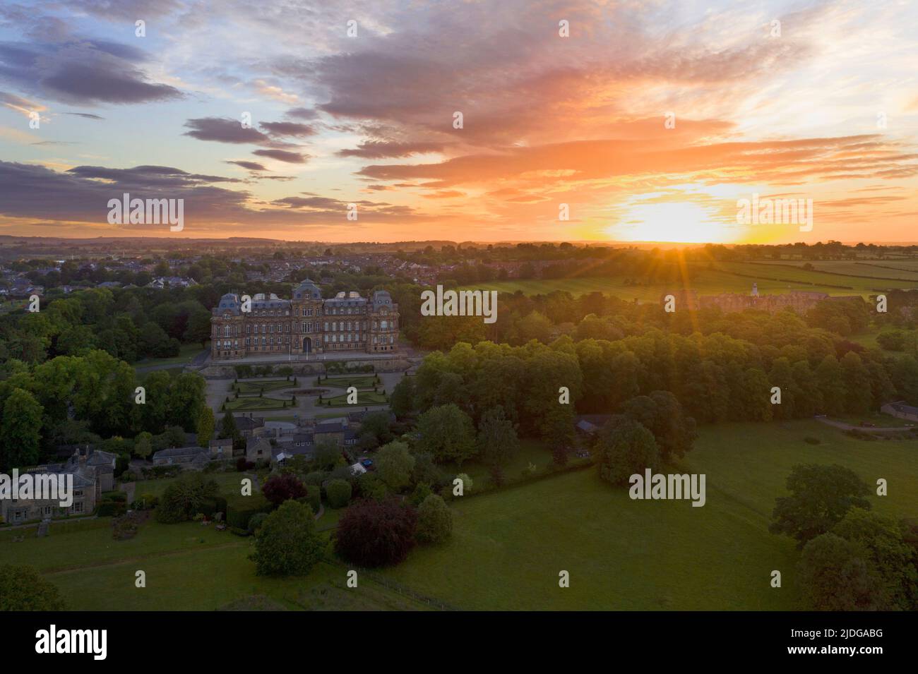 Barnard Castle, Teesdale, County Durham, UK.  21st June 2022. UK Weather. A beautiful summer solstice sun rises over the spectacular French style chateau of the Bowes Museum in Barnard Castle this morning. Credit: David Forster/Alamy Live News Stock Photo