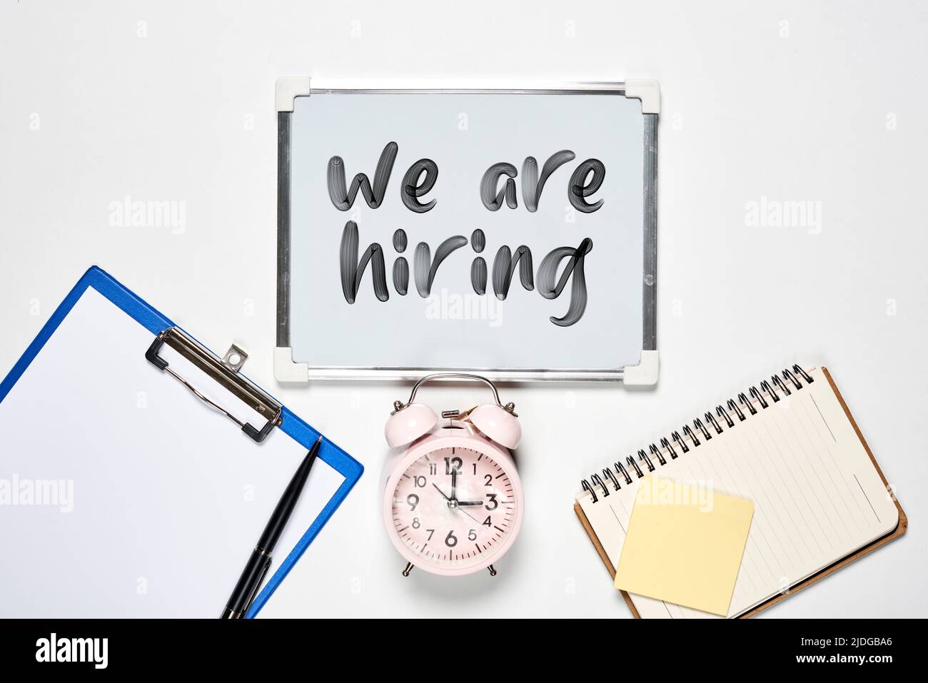 Creative view flat lay with we are hiring text on white backgraund ...