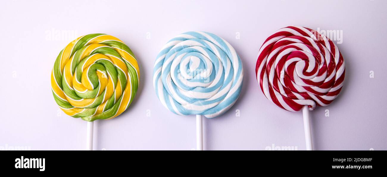 Three lollipops on a white background. Horizontal banner. Stock Photo