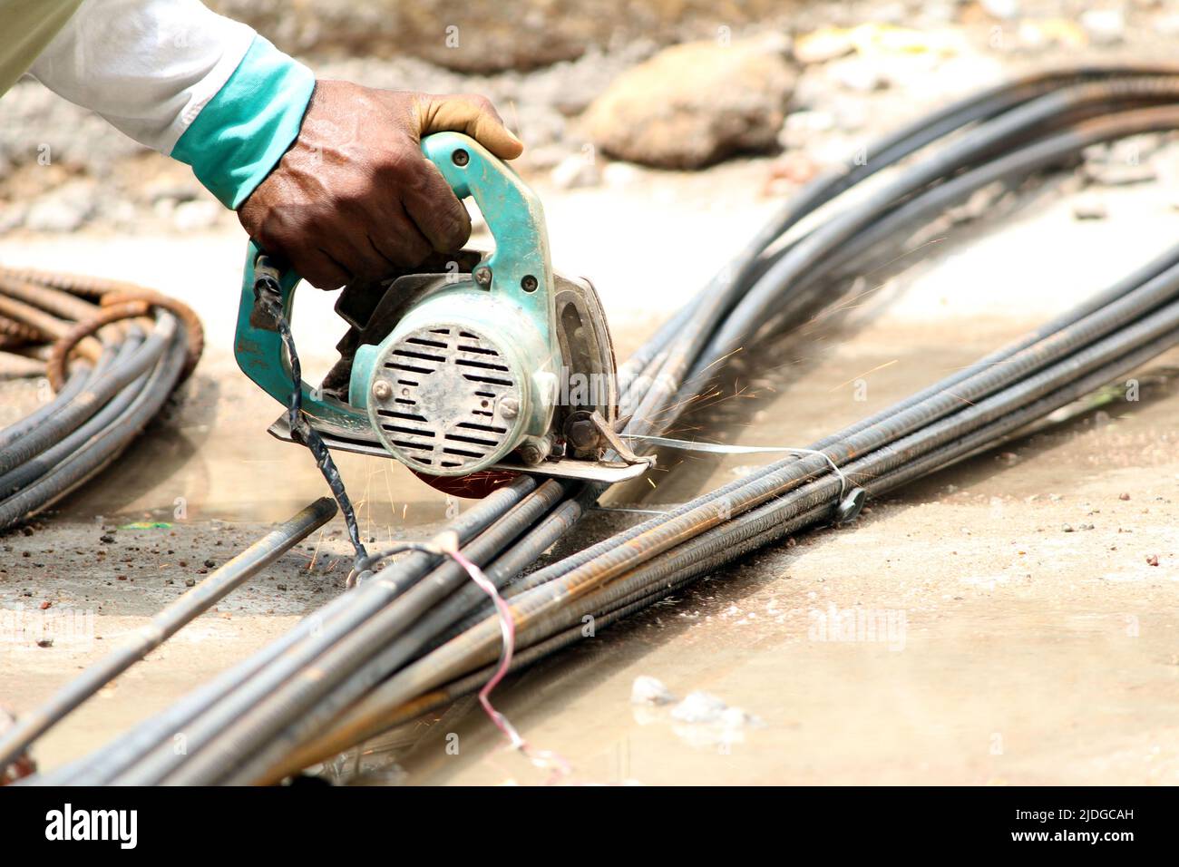 a worker cutting iron rods on construction site Stock Photo - Alamy