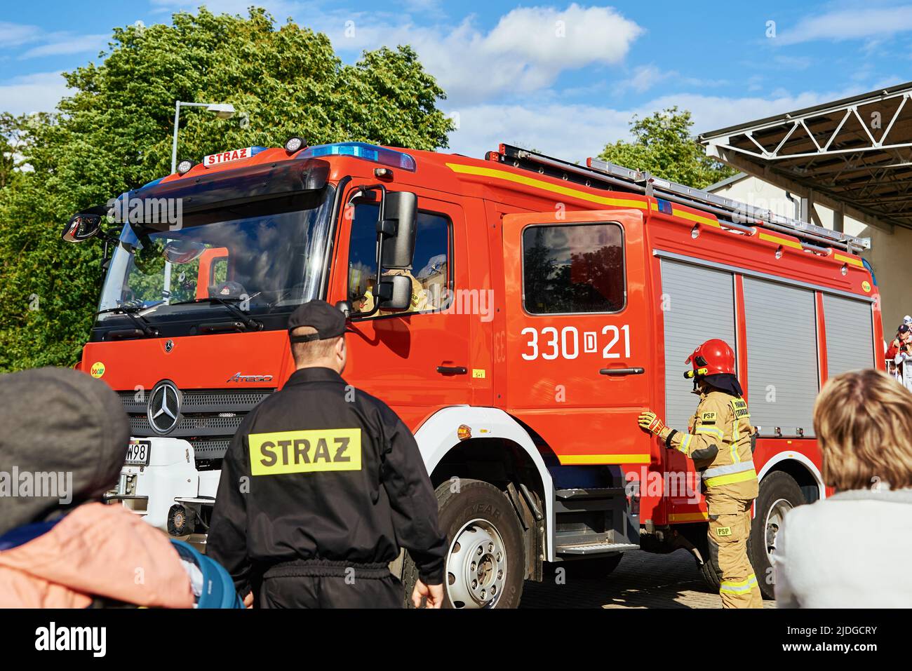 Firefighter brigade near firetruck at city street. Katy Wroclawskie